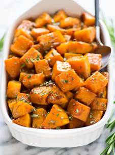 Easy maple roasted butternut squash with cinnamon and fresh rosemary in a dish
