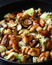 A pan of food with mushrooms and cabbage

AI-generated content may be incorrect.